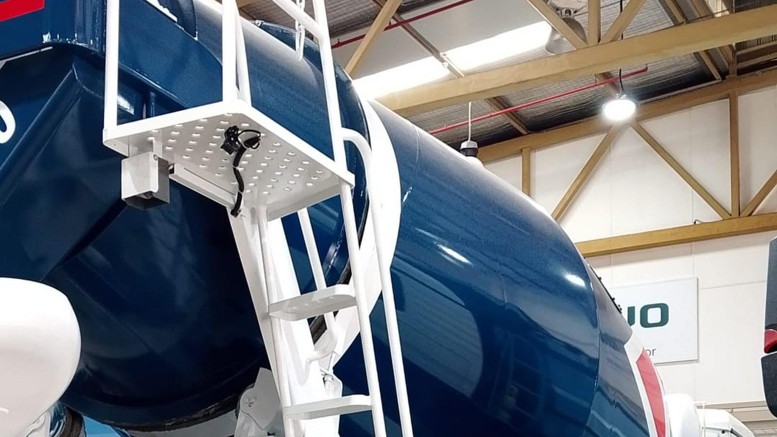 Close-up of the rear drum and access ladder of a cement mixer truck