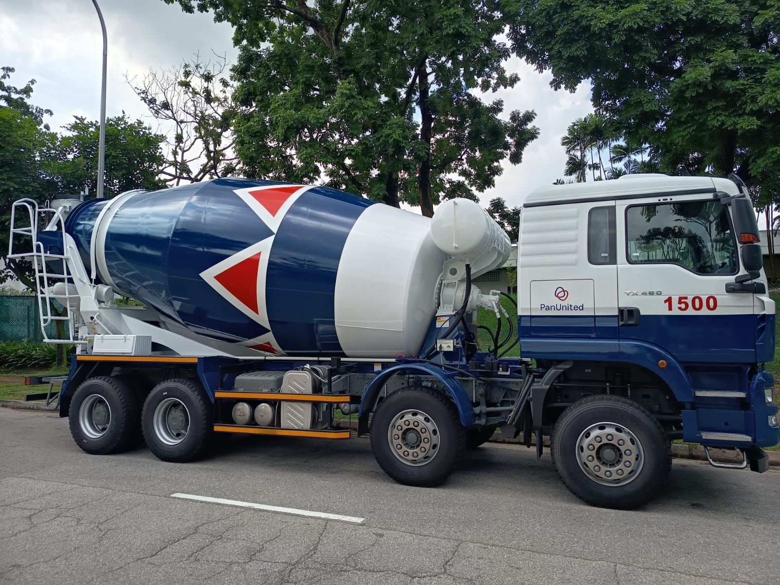 PanUnited cement mixer truck, side view, parked on a Singapore road