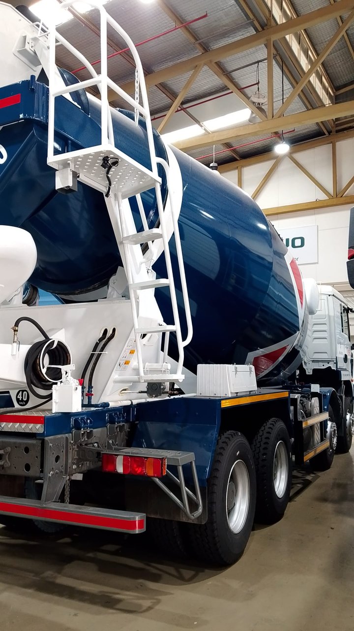 Rear of a PanUnited-livery cement mixer truck, showing the drum, access ladder and rear lights